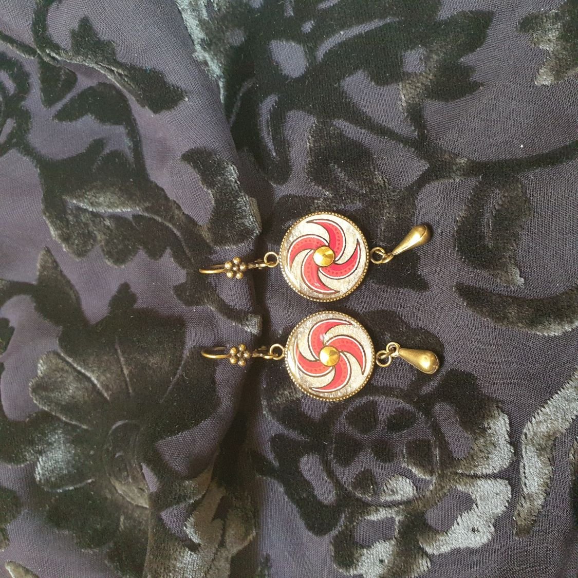 Red spiral dangling earrings