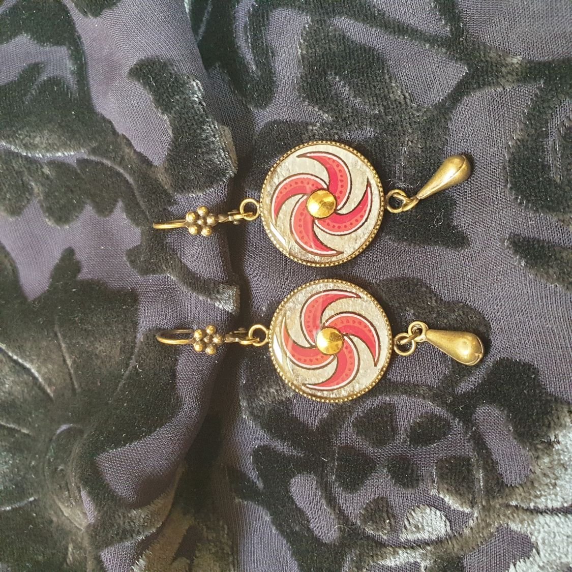 Red spiral dangling earrings