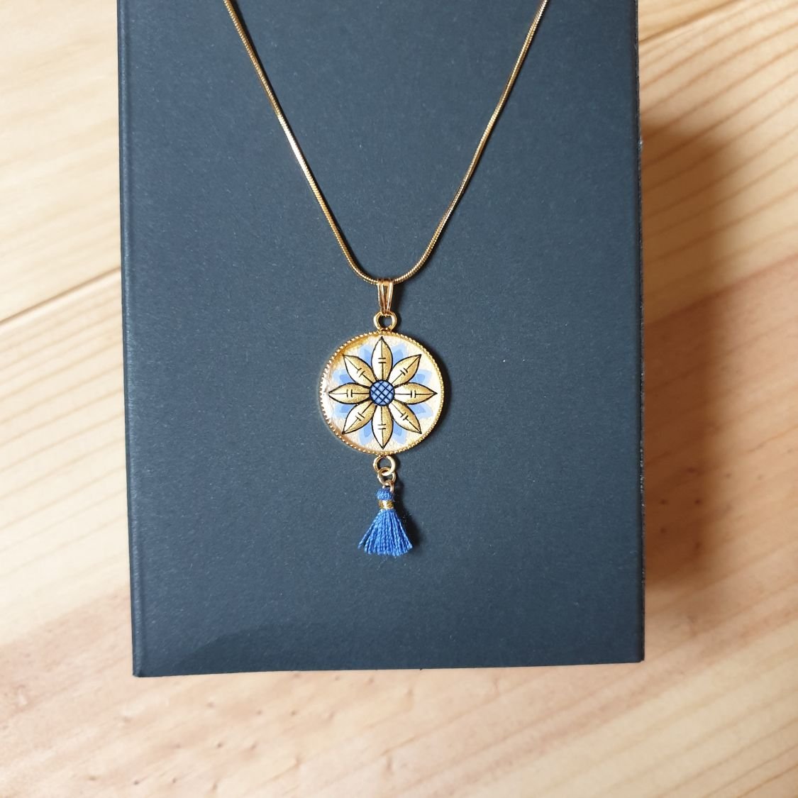 Gold/blue flower pendant necklace on gold chain