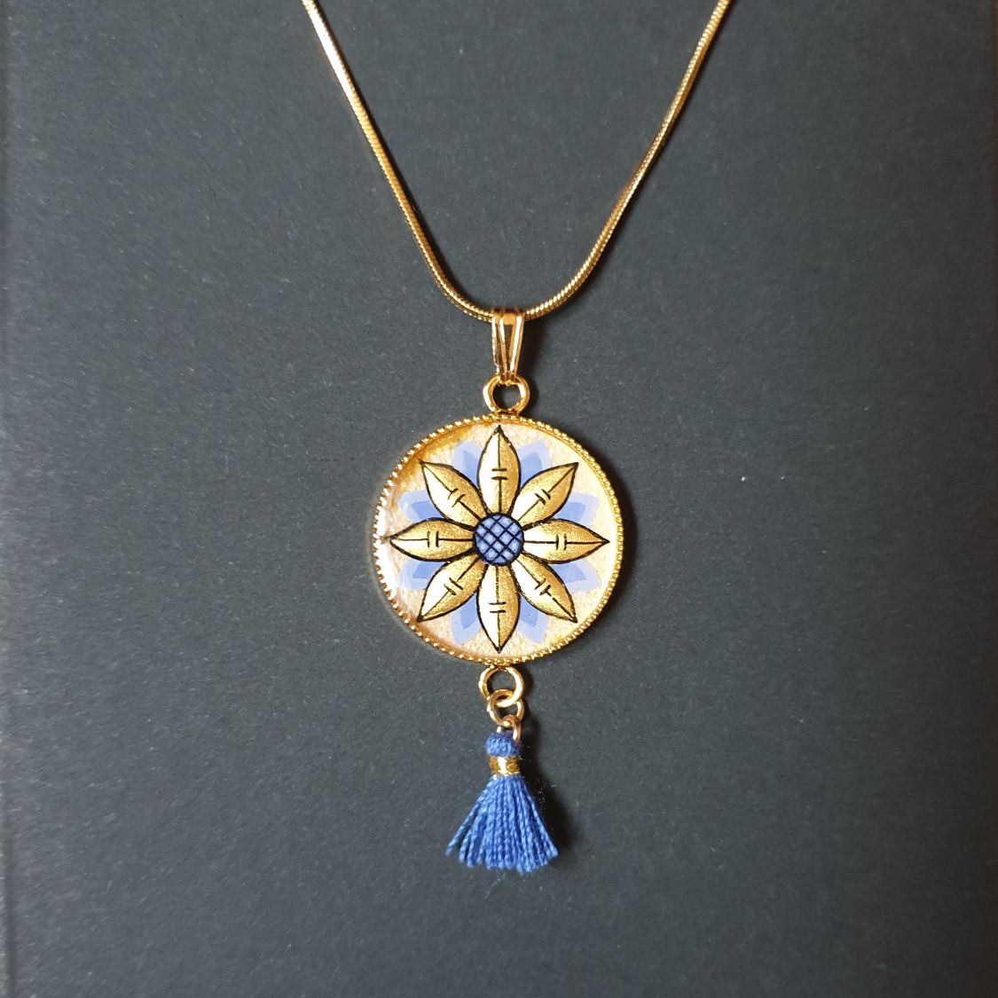 Gold/blue flower pendant necklace on gold chain