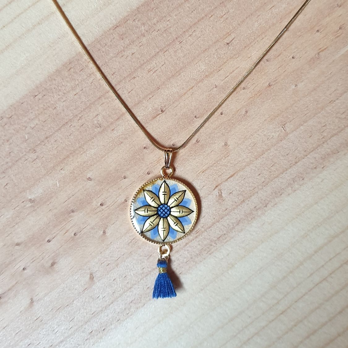 Gold/blue flower pendant necklace on gold chain