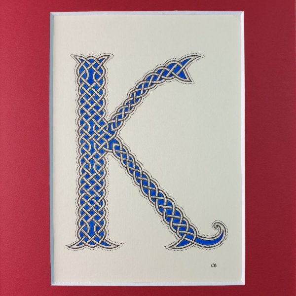 Illuminated letter K with interlacing